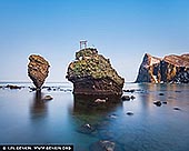  stock photography | Ebisu Iwa and Daikoku Rock, Yoichi, Hokkaido, Japan, Image ID JAPAN-HOKKAIDO-EBISU-IWA-0002. Ebisu Iwa and Daikoku Rock are two iconic rock formations located off the coast of Yoichi, a town on the western coast of Hokkaido, Japan. They are revered for their striking natural beauty and cultural significance, often serving as symbols of the rugged coastal scenery of this region. The two rocks together embody the dual blessings of good fortune, wealth, and safe seas. In the past, these formations may have been focal points for rituals and prayers by local fishermen, who relied on divine protection for bountiful catches and safe returns from the treacherous northern seas. The coast of Yoichi, where Ebisu Iwa and Daikoku Iwa are found, is renowned for its rugged beauty, with dramatic cliffs, crashing waves, and a wide view of the Sea of Japan. Visitors often stop at a viewing area on the mainland to admire these two striking formations, especially during sunset when the rocks are silhouetted against the vibrant sky. These rock formations are not just geological marvels but also cultural landmarks that represent both the natural beauty and the deep spiritual heritage of Yoichi and its maritime history.