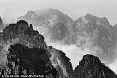 portfolio stock photography | Huangshan Mountains, Cloud-dispelling Pavilion, Xihai (West Sea) Grand Canyon, Baiyun Scenic Area, Huangshan (Yellow Mountains), China, Image ID CHINA-BW-0005. Huang Shan (Yellow Mountain), located in eastern China's Anhui Province, is famous for its countless jagged rock towers, beautifully wind-sculpted pine trees, and seas of swirling clouds. It resembles a sumi painting more than a real place. It is a subject of traditional Chinese paintings, literature and modern photography. It is UNESCO World Heritage Site, and one of China's major tourist destinations.