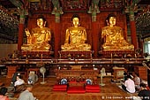  stock photography | In Prayer for Buddha Inside Jogyesa Temple in Seoul, South Korea, Gyeonji-dong, Jongno-gu, Seoul, South Korea, Image ID KR-SEOUL-JOGYESA-0006. 