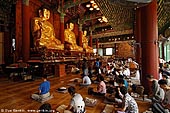  stock photography | In Prayer for Buddha Inside Jogyesa Temple in Seoul, South Korea, Gyeonji-dong, Jongno-gu, Seoul, South Korea, Image ID KR-SEOUL-JOGYESA-0009. 