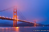 usa stock photography | The Golden Gate Bridge Early in the Morning, San Francisco Bay, California, USA, Image ID US-SAN-FRANCISCO-GOLDEN-GATE-0001. Fog covered the Golden Gate Bridge in San Francisco Bay, California, USA early in the morning in about 20 minutes before sunrise when the entire landscape (bay and hills) is painted with blue light and only the bridge is highlighted with orange vermillion color.