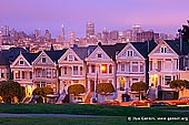 usa stock photography | The Painted Ladies at Dusk, Alamo Square, San Francisco, California, USA, Image ID US-SAN-FRANCISCO-PAINTED-LADIES-0001. The 'Seven Sisters of Postcard Row', also known as the 'Painted Ladies', Victorian style houses at Alamo Square in Haight-Ashbury District, San Francisco, CA, USA with the city skyline in the background on a colourful pink sunset. This row has become (along with the Golden Gate Bridge and Alcatraz) synonymous with San Francisco.